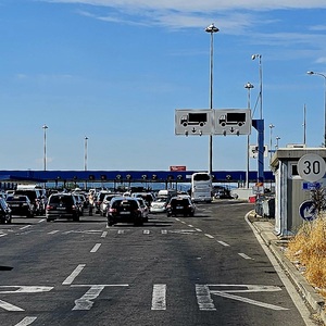 Serbian border. Cars wait an hour, we slip through.